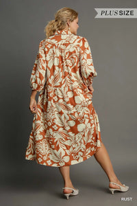 Woman wearing Floral Tiered Midi Shirt Dress-Flowy floral tiered midi shirt dress with 3/4 sleeves in rust + beige print. Boho-chic style in standard & plus sizes for casual or dressy days.