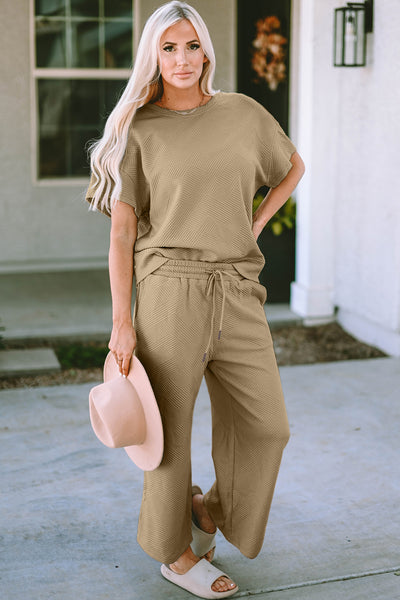 Textured, stretchy, and comfy. This two piece cropped pant with short sleeve top is a great travel set to stay comfortable in the car or plane. Available in a variety of colors and extended sizes.
