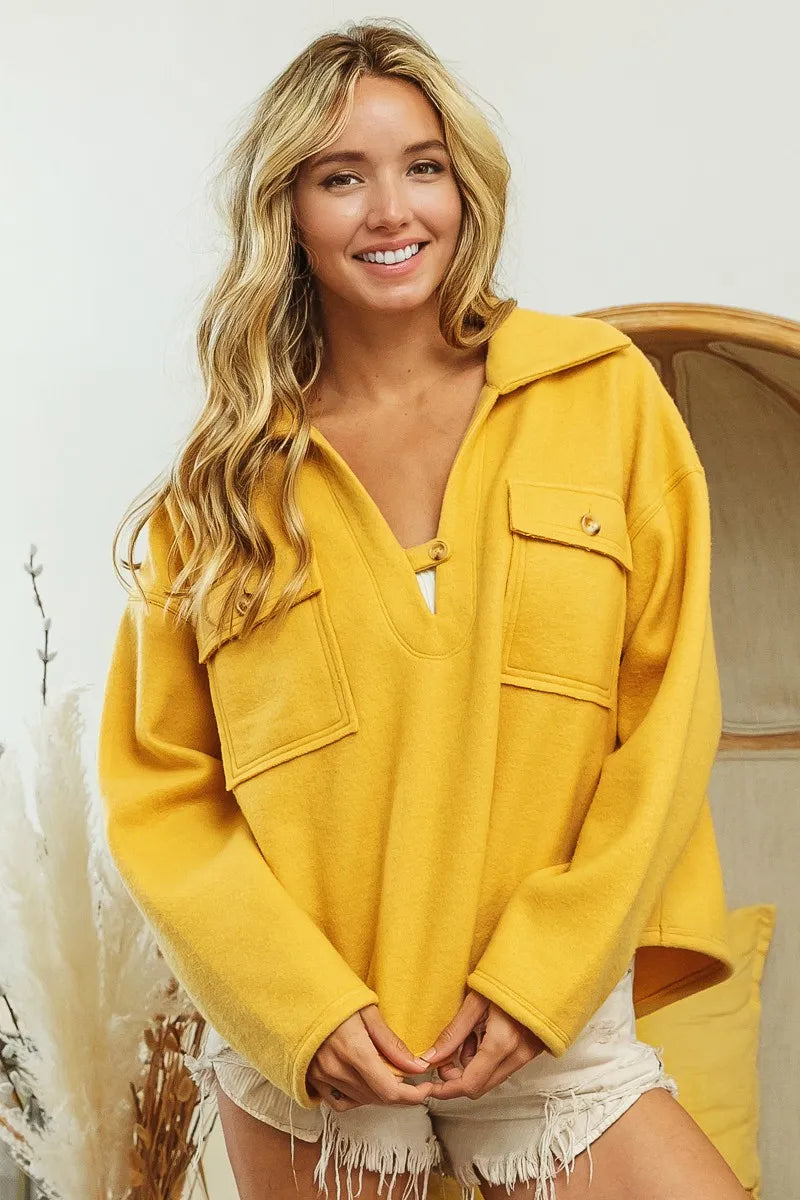 Woman wearing Honey Mustard Fleece Collared Sweatshirt-Fleece collared sweatshirt with flap pockets and button details. Cozy, stylish, and perfect for layering all season long, your new cozy fall favorite.