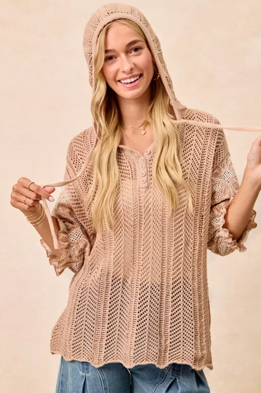 Woman wearing Jacquard Flower Puff Sleeve Hooded Knit Top-This jacquard flower puff sleeve hooded knit top combines intricate floral patterns with a touch of volume in the sleeves for a stylish look, elevate your knitwear.