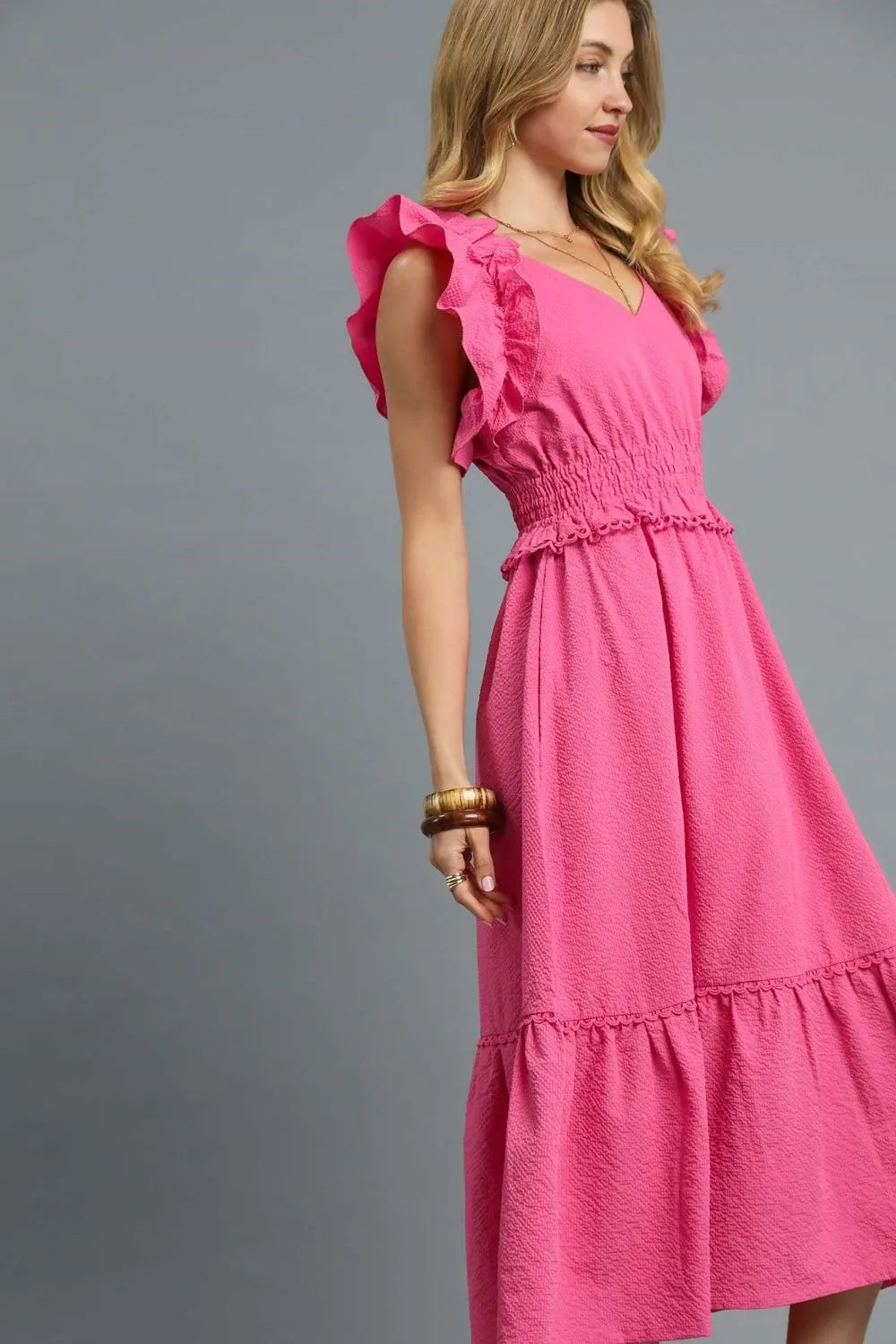 Woman wearing Hot Pink V-Neck Ruffled Cap Sleeve Midi Dress-Stunning midi dress with eye-catching ruffle shoulders and a flattering waist that accentuates your silhouette. Grest for brunch dates and garden parties.