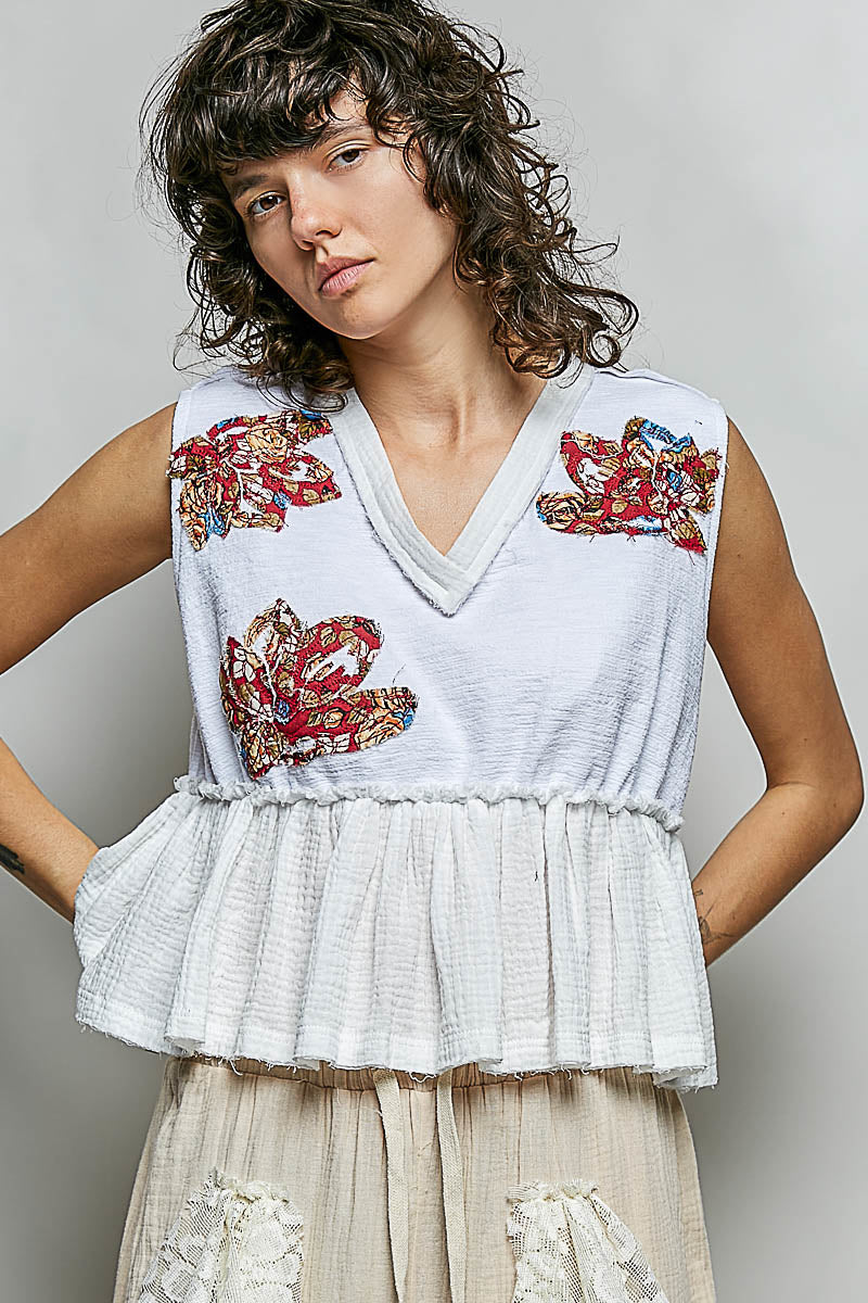 White POL Floral Patch Ruffled Sleeveless Top with V-neck, raw edge, and peplum hem.