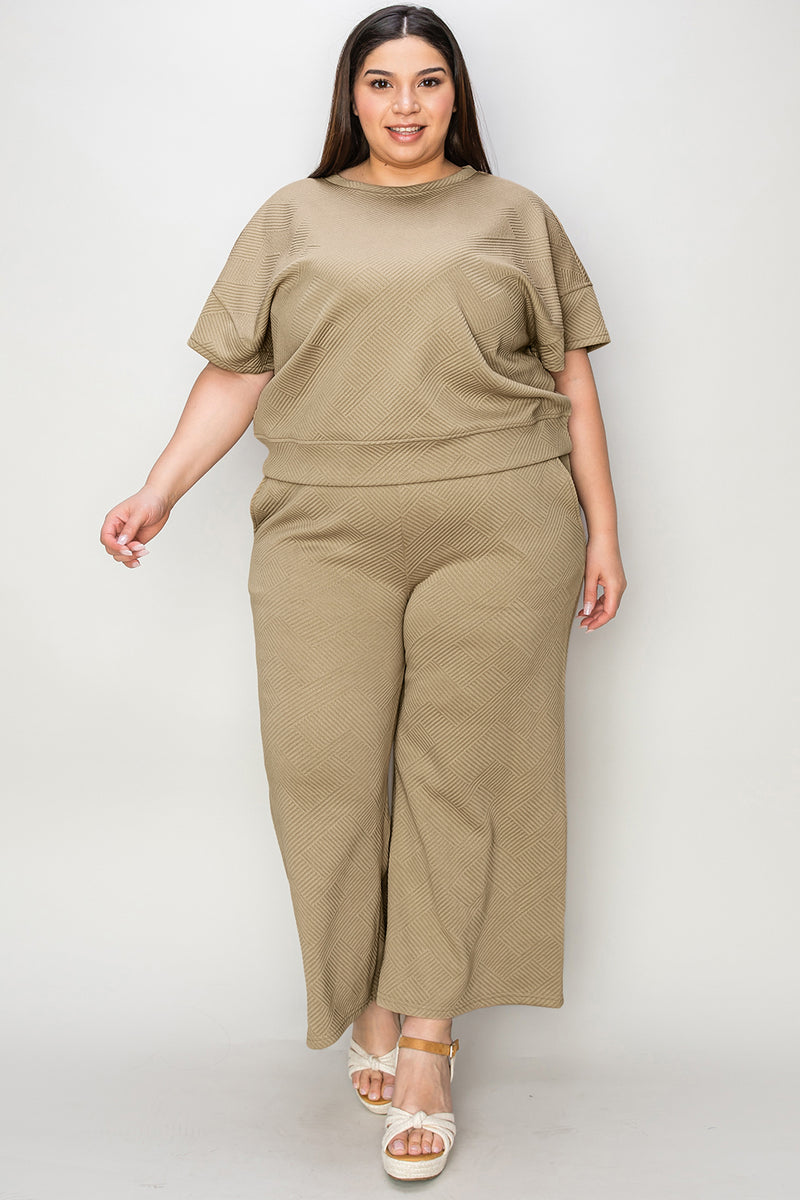 Textured, stretchy, and comfy. This two piece cropped pant with short sleeve top is a great travel set to stay comfortable in the car or plane. Available in a variety of colors and extended sizes.