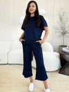 Textured, stretchy, and comfy. This two piece cropped pant with short sleeve top is a great travel set to stay comfortable in the car or plane. Available in a variety of colors and extended sizes.