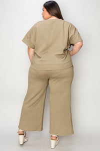 Textured, stretchy, and comfy. This two piece cropped pant with short sleeve top is a great travel set to stay comfortable in the car or plane. Available in a variety of colors and extended sizes.