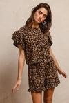 Woman wearing Leopard Print Waffle Texture Layered Ruffle Sleeve Top and Shorts Set-This leopard print set features a leopard print waffle texture top with layered ruffle sleeves, paired with matching shorts for a coordinated and stylish look. 