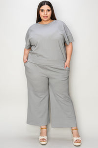 Textured, stretchy, and comfy. This two piece cropped pant with short sleeve top is a great travel set to stay comfortable in the car or plane. Available in a variety of colors and extended sizes.