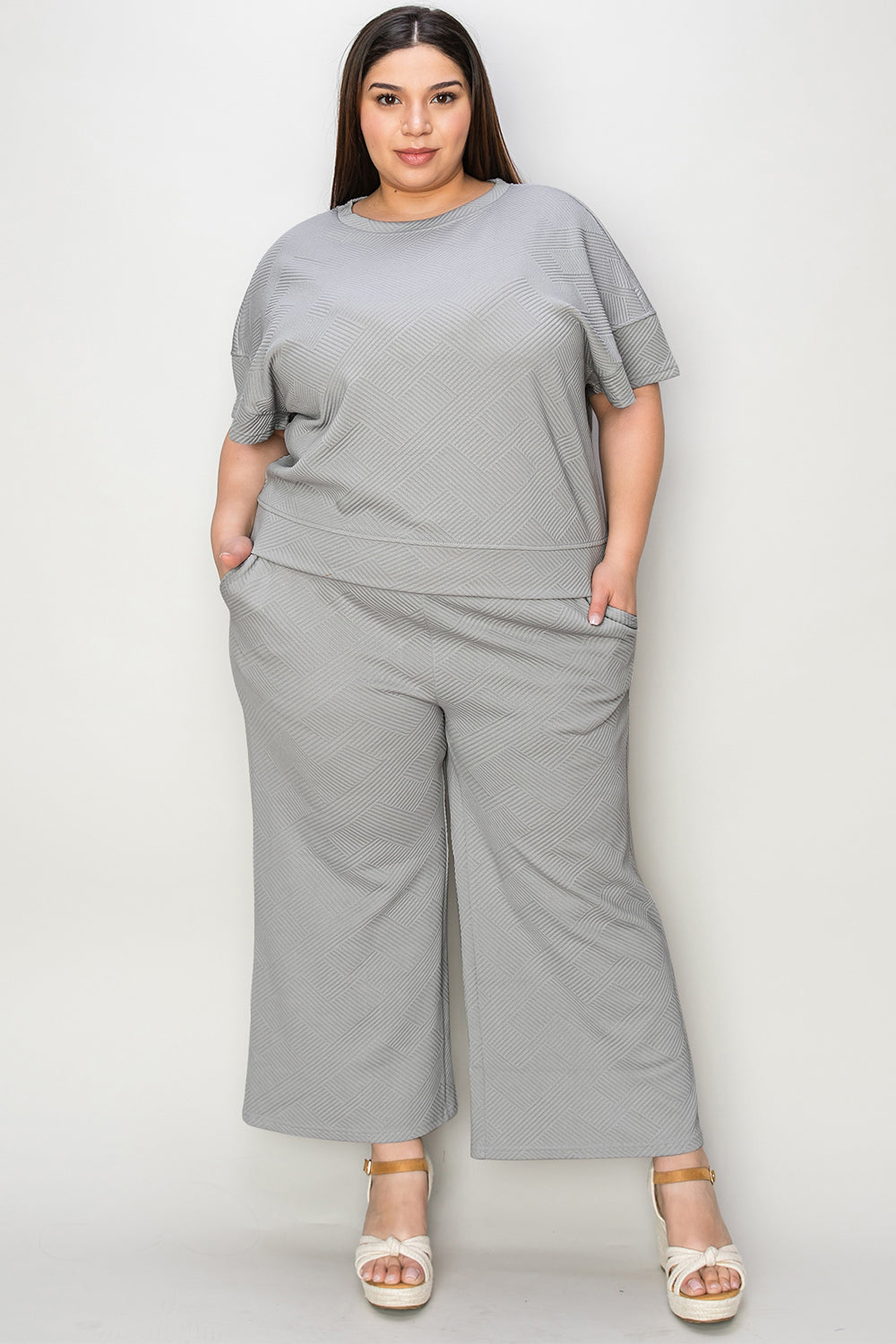Textured, stretchy, and comfy. This two piece cropped pant with short sleeve top is a great travel set to stay comfortable in the car or plane. Available in a variety of colors and extended sizes.