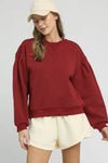 Burgundy Sweatshirt with Pleated Detail-Cozy meets chic in this burgundy pleated sweatshirt. A fall-ready round neck pullover with soft sleeve details, perfect for layering or lounging. Sizes XS–L.-Reef Love Boutique