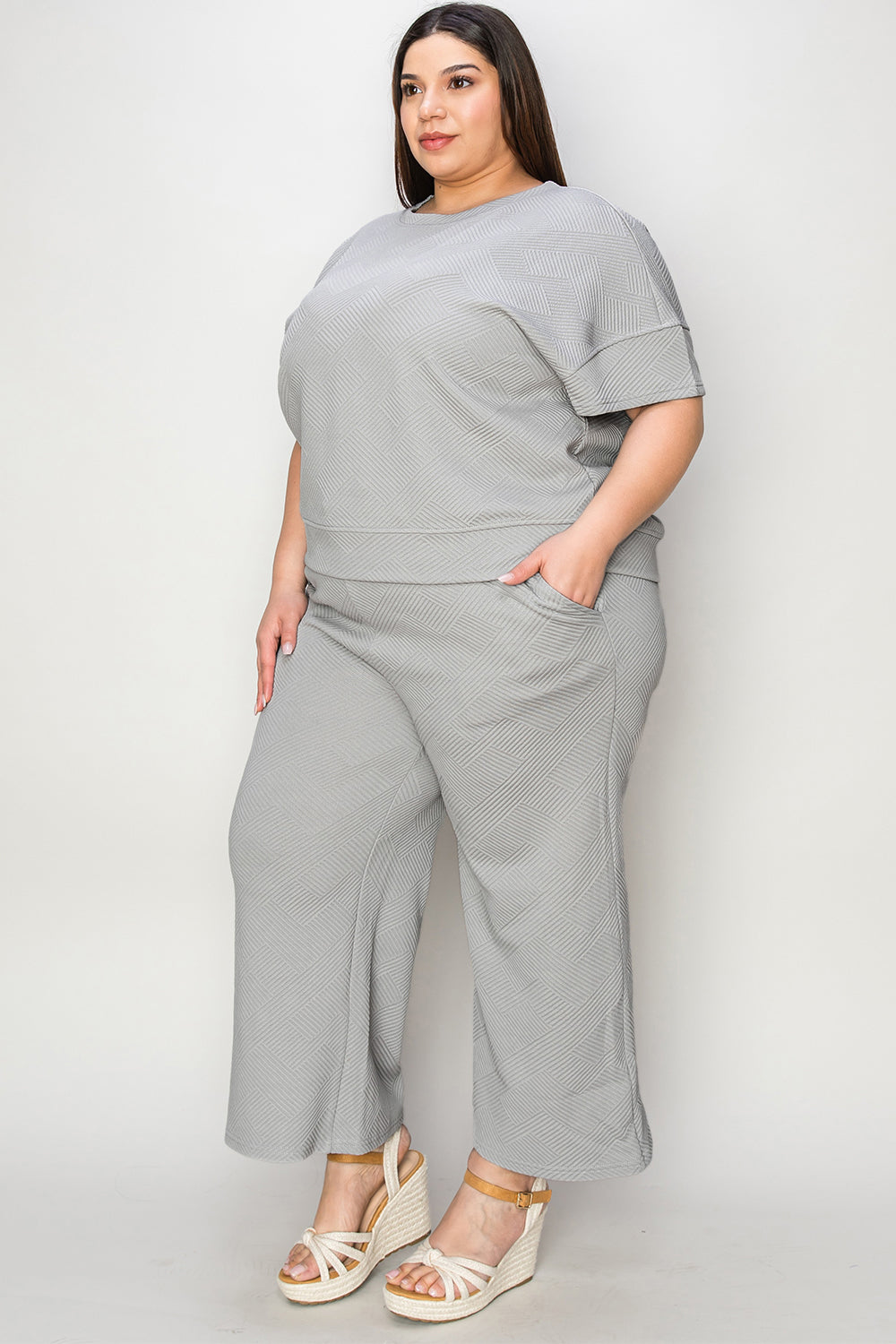 Textured, stretchy, and comfy. This two piece cropped pant with short sleeve top is a great travel set to stay comfortable in the car or plane. Available in a variety of colors and extended sizes.