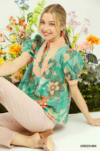 Fashionable green mixed abstract print puff sleeve blouse with a V-neckline, made from 100% cotton.