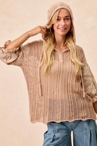 Woman wearing Jacquard Flower Puff Sleeve Hooded Knit Top-This jacquard flower puff sleeve hooded knit top combines intricate floral patterns with a touch of volume in the sleeves for a stylish look, elevate your knitwear.