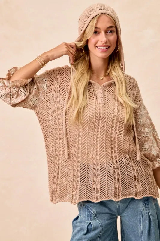 Woman wearing Jacquard Flower Puff Sleeve Hooded Knit Top-This jacquard flower puff sleeve hooded knit top combines intricate floral patterns with a touch of volume in the sleeves for a stylish look, elevate your knitwear.