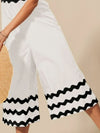Shop Scallop Ric Rac Trimmed Wide Leg Jumpsuit-Scallop Ric Rac Trimmed Wide Leg Jumpsuit - Effortless Style, designed to impress with its distinctive scallop ric rac trim that adds a playful yet refined touch. -Reef Love Boho-Chic Boutique