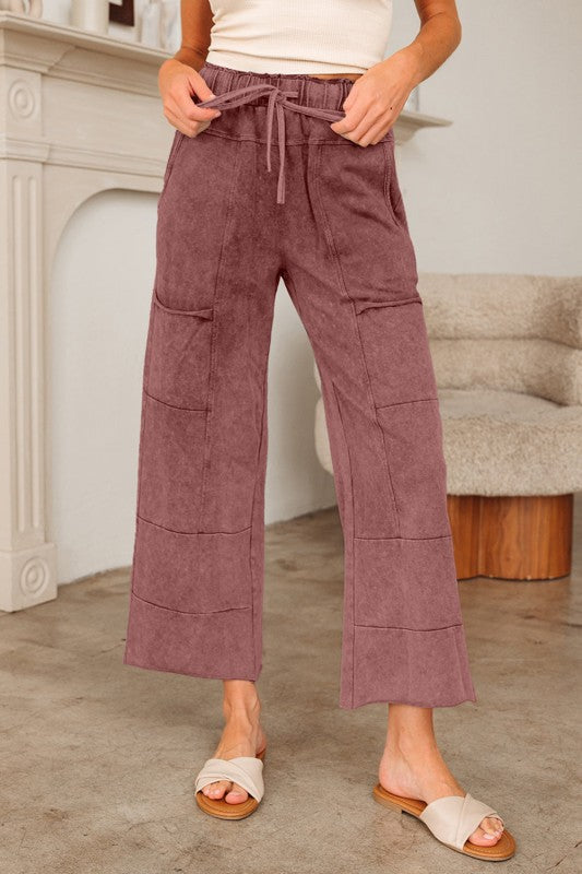 Person wearing mauve corduroy pants in a living room setting