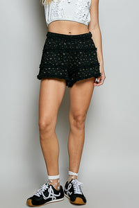 Black POL Ruffled Floral Shorts with a vintage wash and delicate floral print, perfect for warm-weather style.