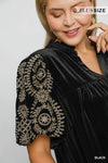 Woman wearing Velvet Embroidered Sleeve Blouse-This velvet embroidered sleeve blouse combines luxe velvet with embroidery for a sophisticated and stylish look. Perfect for adding a touch of glamour to your outfit.