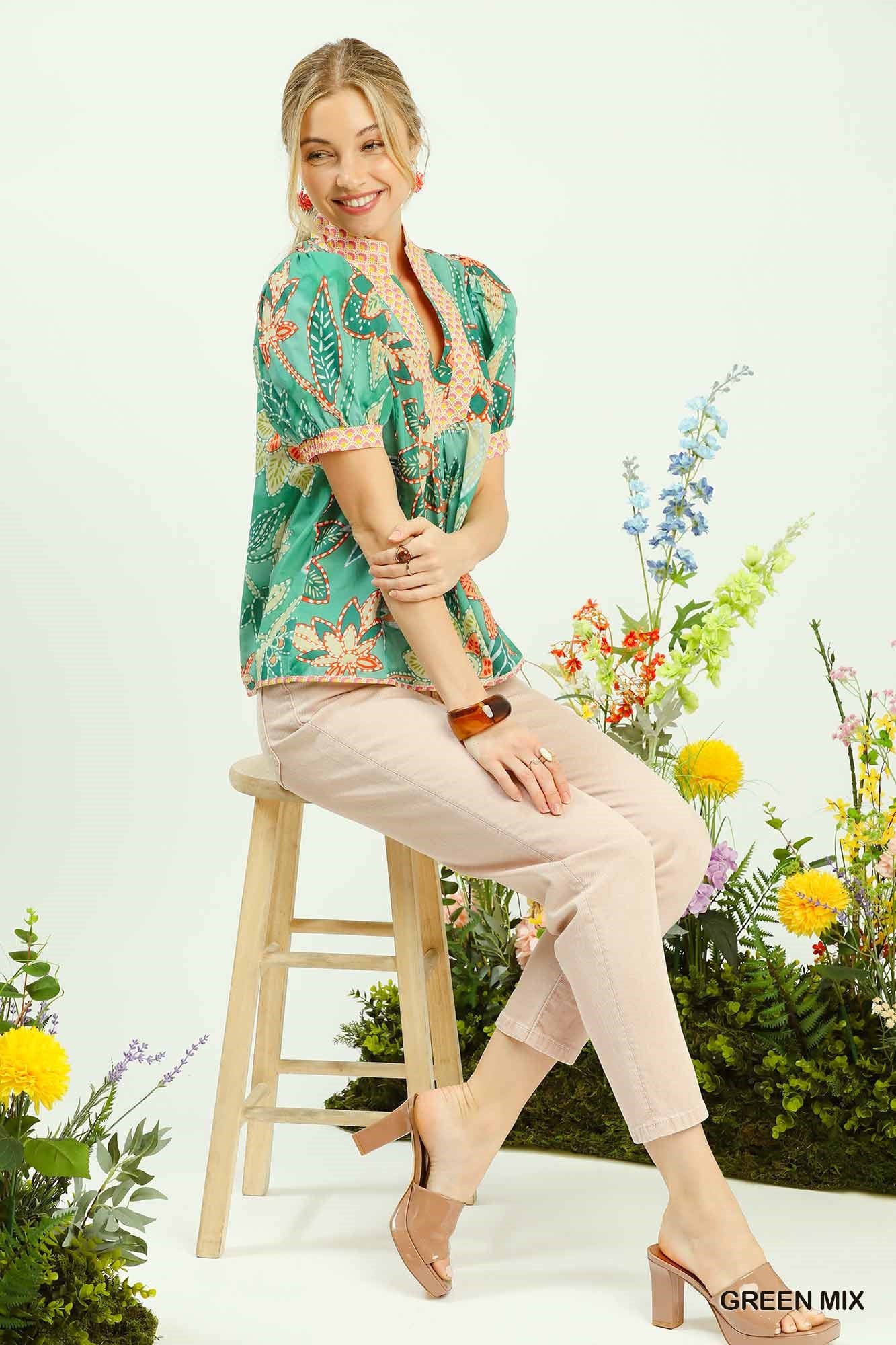 Fashionable green mix abstract print puff sleeve blouse with V-neck, paired with light pink pants.