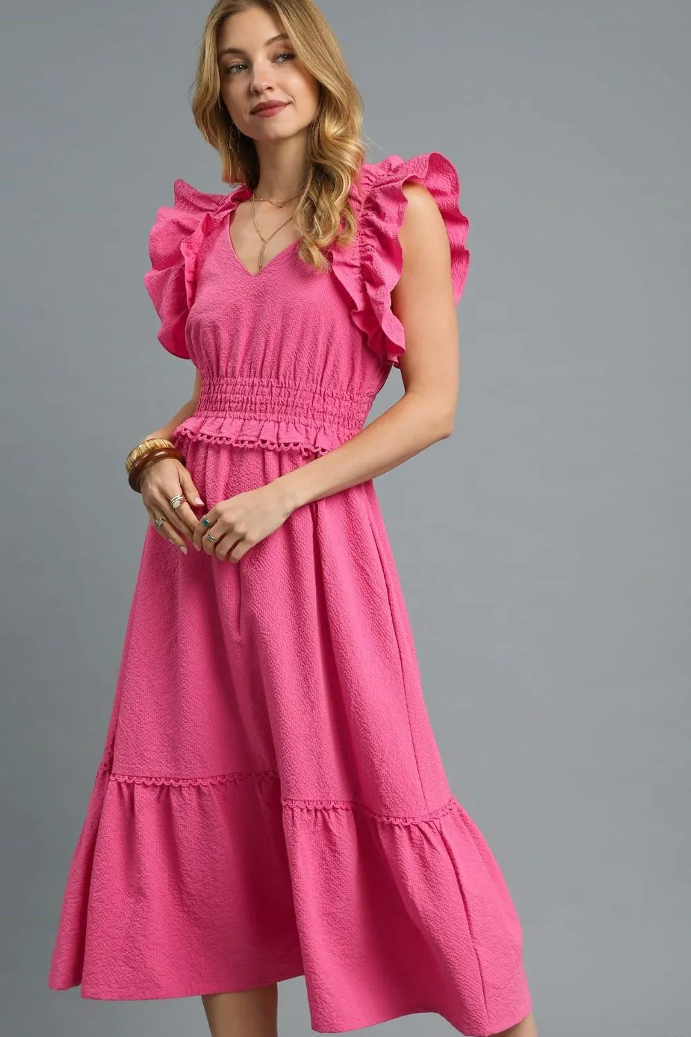 Woman wearing Hot Pink V-Neck Ruffled Cap Sleeve Midi Dress-Stunning midi dress with eye-catching ruffle shoulders and a flattering waist that accentuates your silhouette. Grest for brunch dates and garden parties.