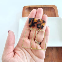 Shop Ariana Earrings - Tortoise-Bold tortoise statement earrings with gold trapezoid charms. Lightweight, hypoallergenic, and perfect for elevating everyday or night-out looks.-available at Reef Love online boho-chic boutique