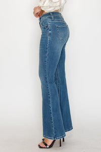 Blue jeans worn by a person on a white background