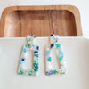 Shop Avery Spring Fling Drop Earrings-Avery Spring Fling Drop Earrings with confetti acrylic charms in cool blue and teal tones. Lightweight and fresh—perfect for spring days and breezy outfits.-available at Reef Love online boho-chic boutique