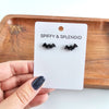 Shop Bat Studs - Black-Black bat stud earrings made from lightweight acrylic with hypoallergenic posts. The perfect spooky accessory for Halloween or fun everyday gothic style.-available at Reef Love online boho-chic boutique