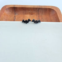 Shop Bat Studs - Black-Black bat stud earrings made from lightweight acrylic with hypoallergenic posts. The perfect spooky accessory for Halloween or fun everyday gothic style.-available at Reef Love online boho-chic boutique