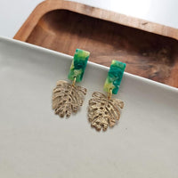 Shop Belize Earrings - Green with Gold Monstera-Mini green acrylic stud earrings with gold monstera charms. Lightweight, hypoallergenic, and full of tropical charm—perfect for everyday or vacation wear.-available at Reef Love online boho-chic boutique