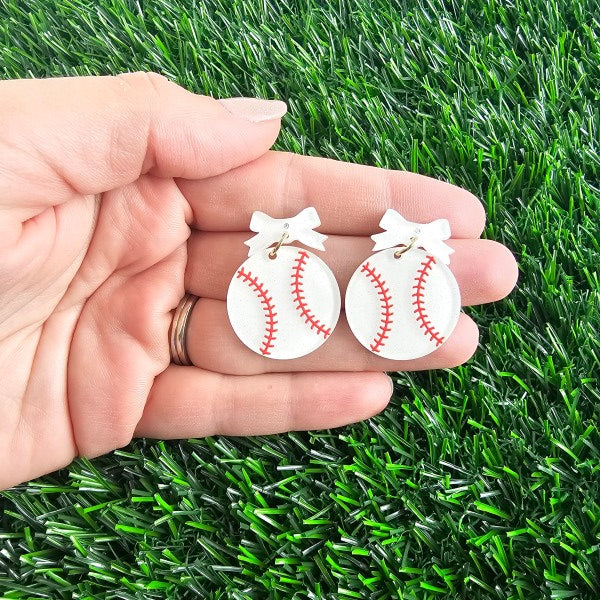 Bow Baseball Earrings-Hit your game day look out of the park with our Game Day Bow Baseball Earrings! Featuring a sweet white bow and a sparkly red-stitched baseball charm.