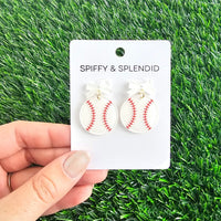 Bow Baseball Earrings-Hit your game day look out of the park with our Game Day Bow Baseball Earrings! Featuring a sweet white bow and a sparkly red-stitched baseball charm.