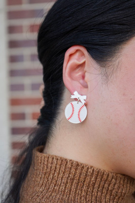 Bow Baseball Earrings-Hit your game day look out of the park with our Game Day Bow Baseball Earrings! Featuring a sweet white bow and a sparkly red-stitched baseball charm.