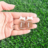 Bow Football Earrings-Football Season Must-have Earrings. Cheer in style with our Game Day Bow Football Earrings! Featuring a dainty white bow paired with a glittery brown football.