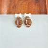 Bow Football Earrings-Football Season Must-have Earrings. Cheer in style with our Game Day Bow Football Earrings! Featuring a dainty white bow paired with a glittery brown football.