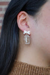 Bow Football Earrings-Football Season Must-have Earrings. Cheer in style with our Game Day Bow Football Earrings! Featuring a dainty white bow paired with a glittery brown football.