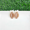 Bow Football Earrings-Football Season Must-have Earrings. Cheer in style with our Game Day Bow Football Earrings! Featuring a dainty white bow paired with a glittery brown football.