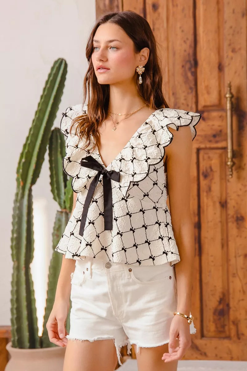 Bow Texture Jacquard Woven Blouse-Black and white jacquard woven blouse with bow tie, scallop trim, and V-neckline. Elegant fitted top for chic workwear or polished casual looks.-Reef Love