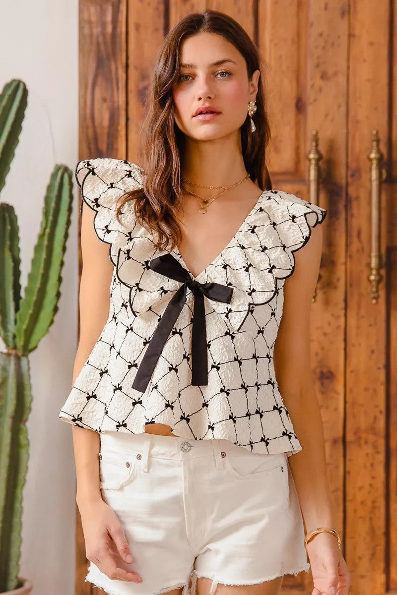Bow Texture Jacquard Woven Blouse-Black and white jacquard woven blouse with bow tie, scallop trim, and V-neckline. Elegant fitted top for chic workwear or polished casual looks.-Reef Love