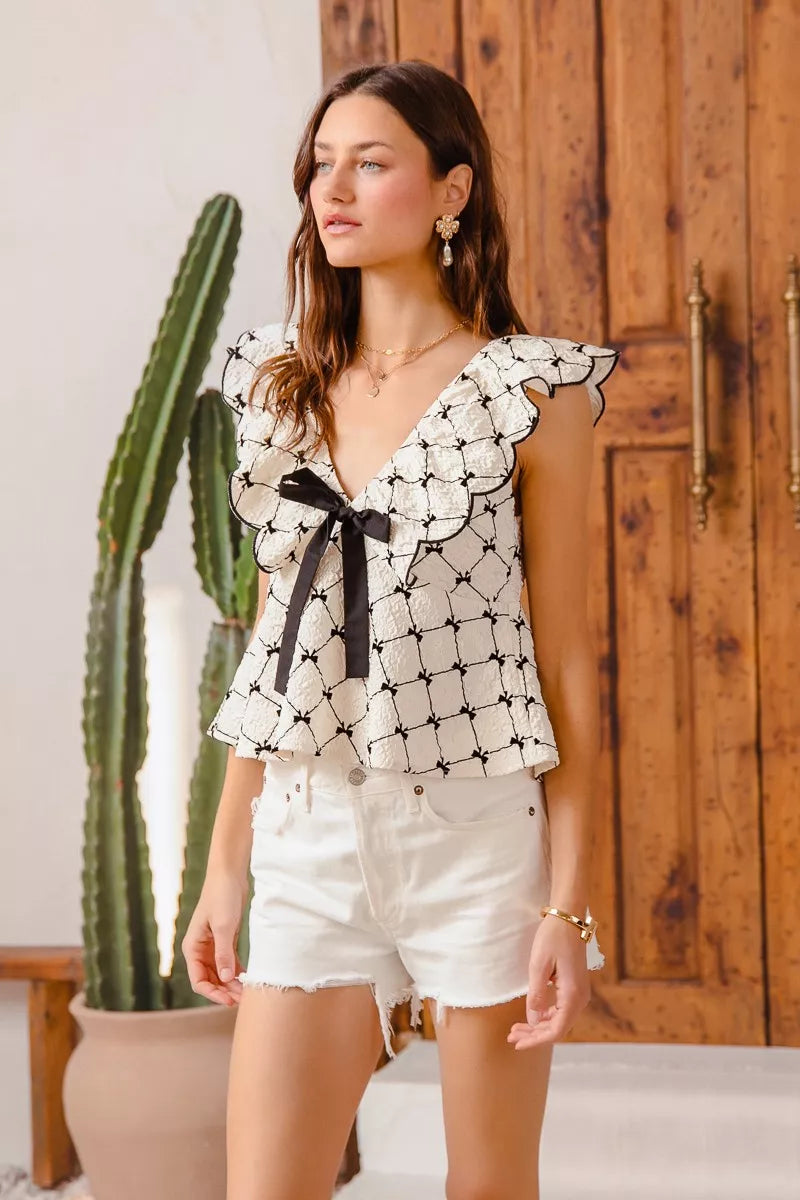 Bow Texture Jacquard Woven Blouse-Black and white jacquard woven blouse with bow tie, scallop trim, and V-neckline. Elegant fitted top for chic workwear or polished casual looks.-Reef Love