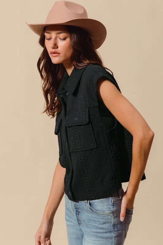 Shop Cable Quilting Stitch Button Up Knit Vest-Elevate your fall layers with our cable quilting stitch button-up knit vest. Featuring textured cable knit, functional pockets, and a structured silhouette perfect for layering.-available at Reef Love online boho-chic boutique