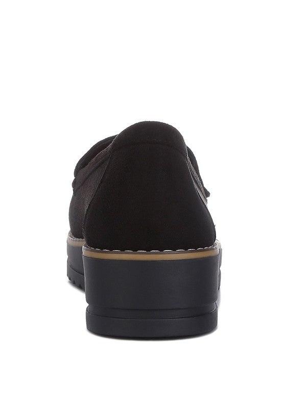 Daiki platform lug sole tassel loafers in soft micro suede with cushioned insole. A chic, edgy update to classic loafers
