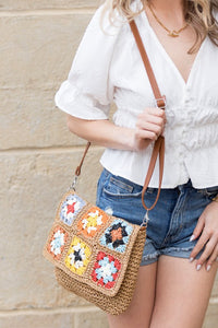 Crochet Woven Crossbody with flower accent. 