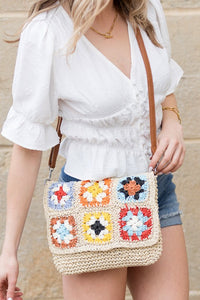 Crochet Woven Crossbody with flower accent. 