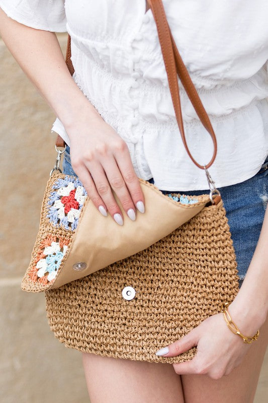 Crochet Woven Crossbody with flower accent. 