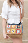 Foldover Crochet Woven Crossbody with flower accent. 