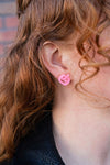 Shop Jack O Lantern Pumpkin Studs - Pink Glitter-Pink glitter jack o’ lantern earrings with hypoallergenic posts. Lightweight, festive, and fun—add a flirty twist to your Halloween or fall accessory lineup.-available at Reef Love online boho-chic boutique