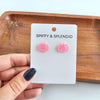 Shop Jack O Lantern Pumpkin Studs - Pink Glitter-Pink glitter jack o’ lantern earrings with hypoallergenic posts. Lightweight, festive, and fun—add a flirty twist to your Halloween or fall accessory lineup.-available at Reef Love online boho-chic boutique