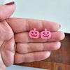 Shop Jack O Lantern Pumpkin Studs - Pink Glitter-Pink glitter jack o’ lantern earrings with hypoallergenic posts. Lightweight, festive, and fun—add a flirty twist to your Halloween or fall accessory lineup.-available at Reef Love online boho-chic boutique