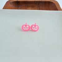 Shop Jack O Lantern Pumpkin Studs - Pink Glitter-Pink glitter jack o’ lantern earrings with hypoallergenic posts. Lightweight, festive, and fun—add a flirty twist to your Halloween or fall accessory lineup.-available at Reef Love online boho-chic boutique