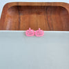 Shop Jack O Lantern Pumpkin Studs - Pink Glitter-Pink glitter jack o’ lantern earrings with hypoallergenic posts. Lightweight, festive, and fun—add a flirty twist to your Halloween or fall accessory lineup.-available at Reef Love online boho-chic boutique